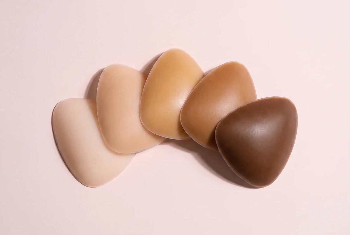 Five Sculpette adhesive bra inserts fanned out in Porcelain, Nude, Honey, Caramel and Cocoa shades