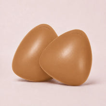 A pair of The Sculpt adhesive bra inserts in Caramel standing side by side