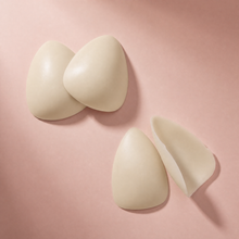 The Sculpt in Porcelain, the pair standing with a third piece turned to show the adhesive face