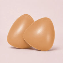 A pair of The Sculpt adhesive bra inserts in Honey standing side by side